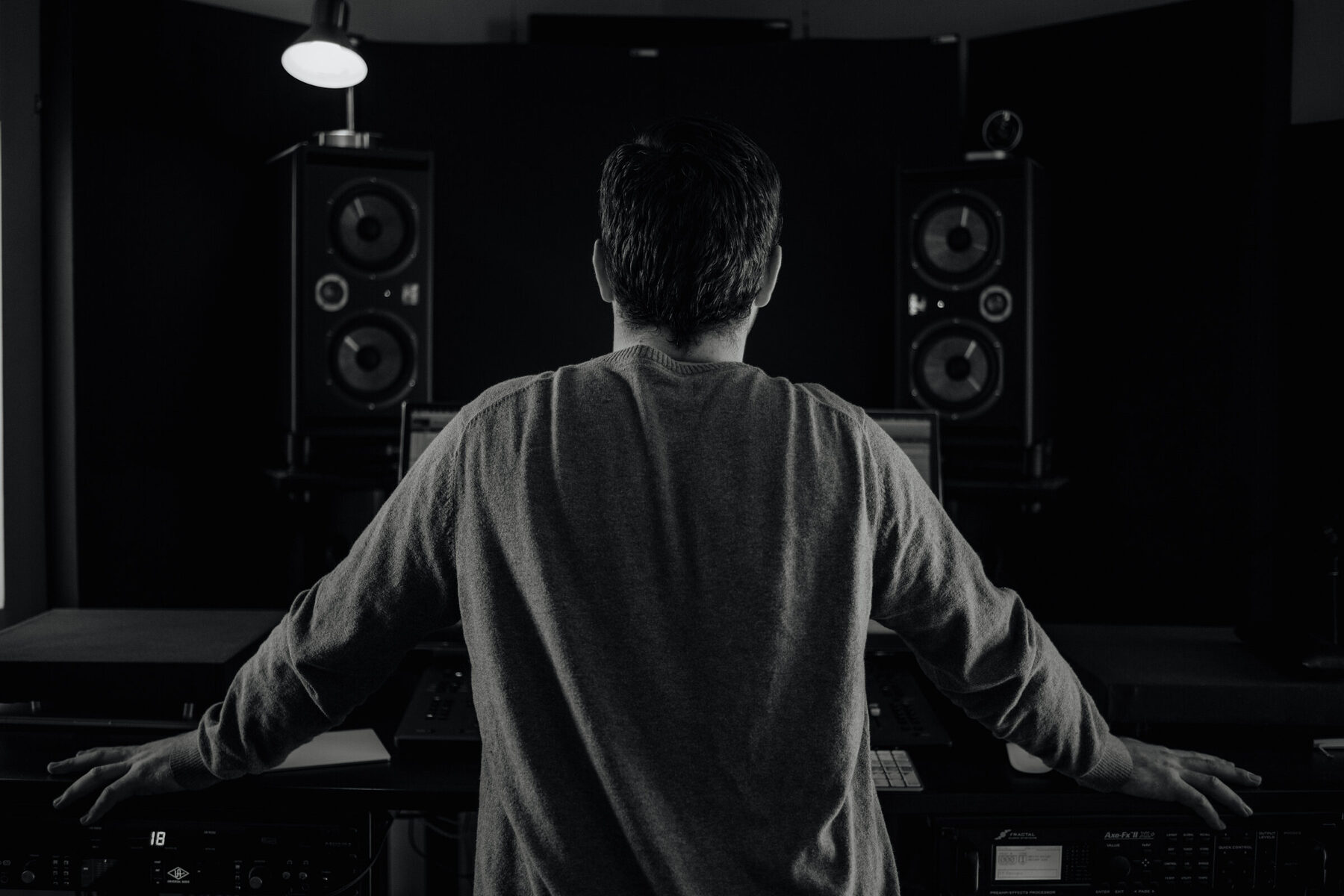 Ryan at the console, arms braced, facing the monitors