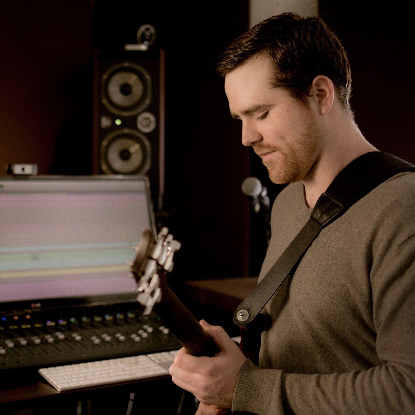 Ryan at the console, studying a guitar neck